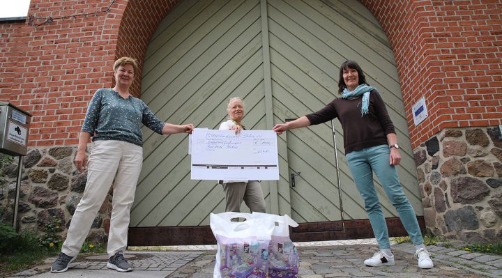 Die beiden Bibliotheksmitarbeiterinnen Roswitha Ackermann (links) und Petra Kather (rechts) nehmen den Spendenscheck von Barbara Hink entgegen. Foto: Marcel Gäding